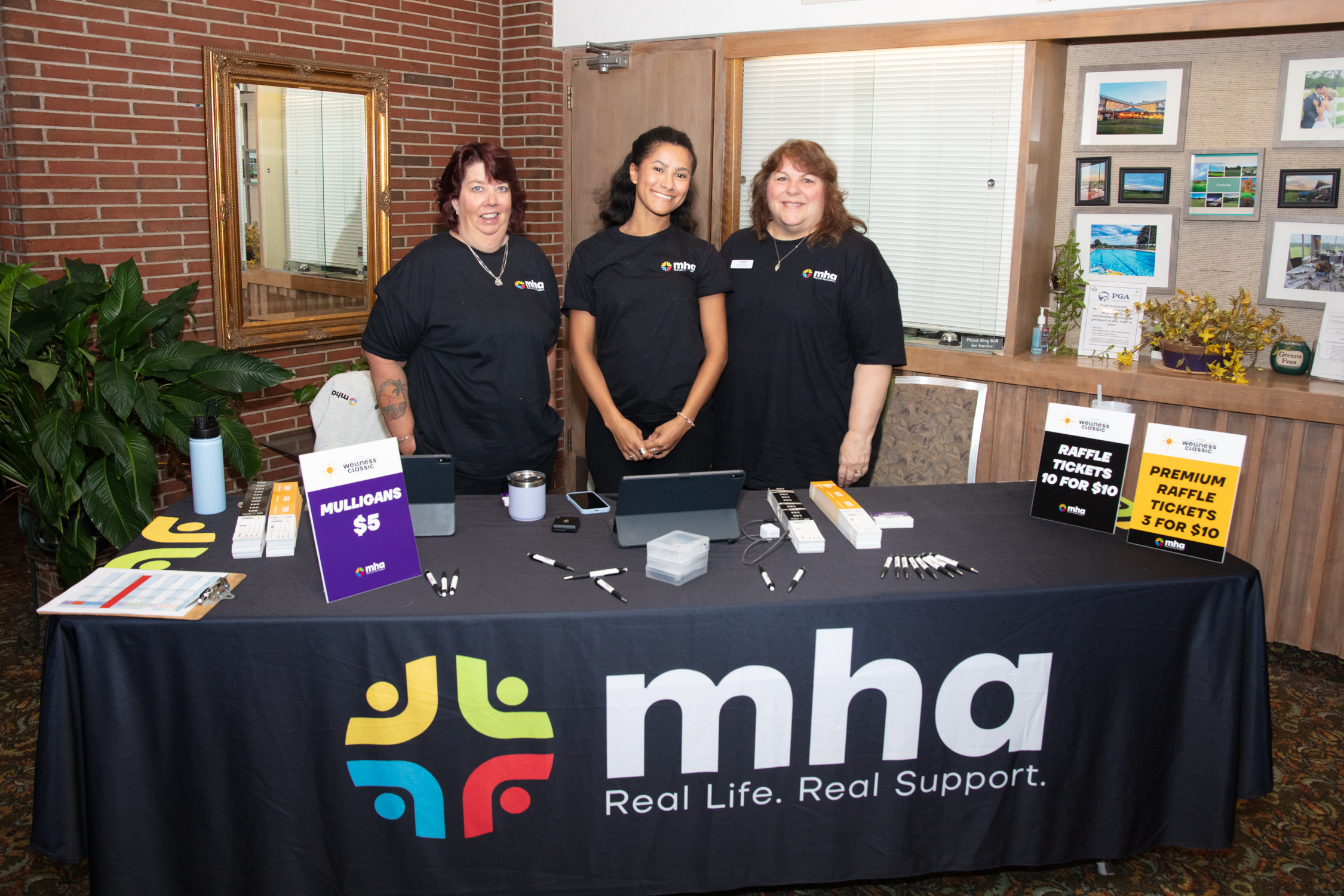 Volunteers at the check-in table for the MHA golf tournament fundraiser